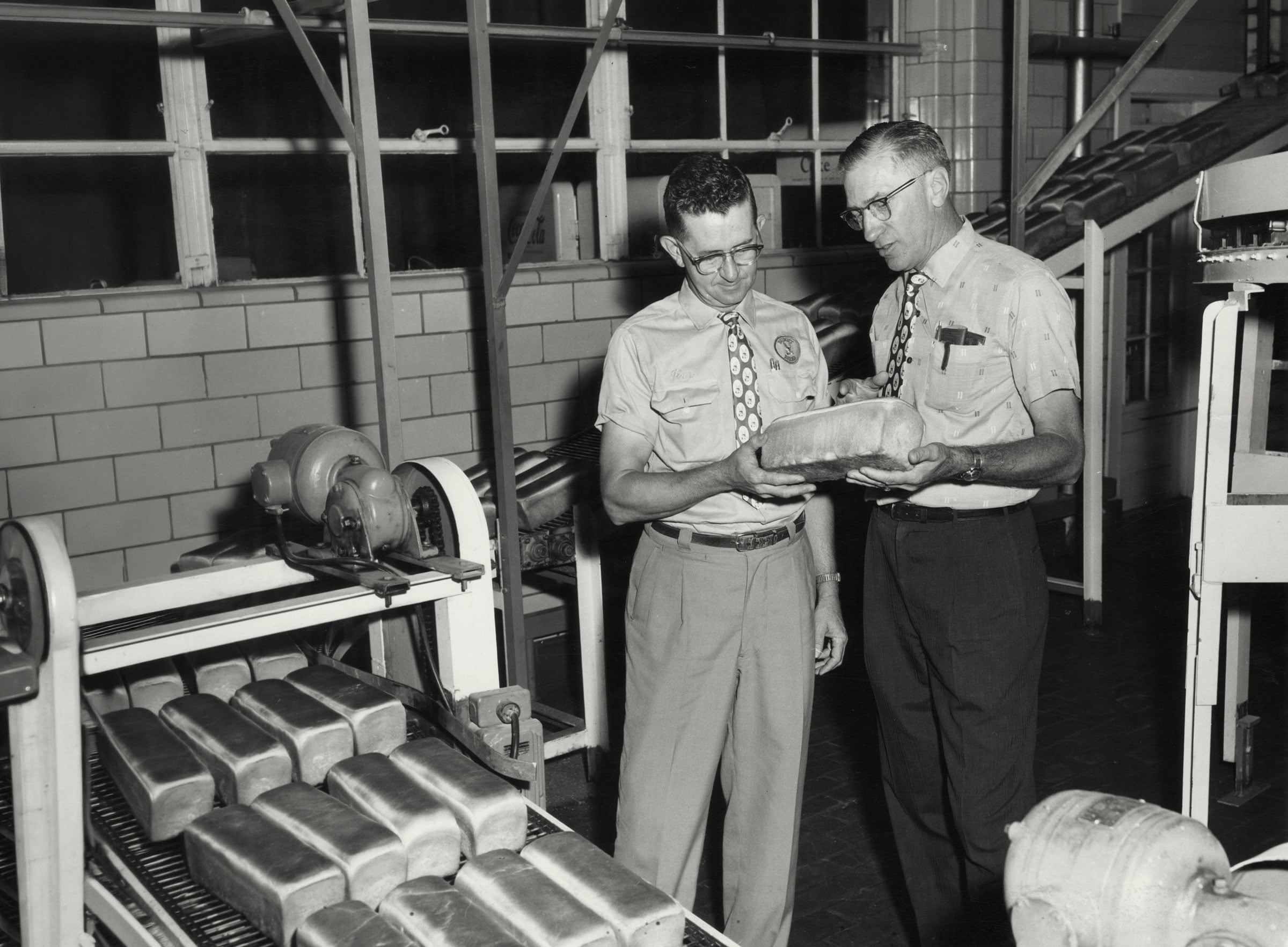 Vintage Lewis Bakeries workers inspecting bread on the production line
